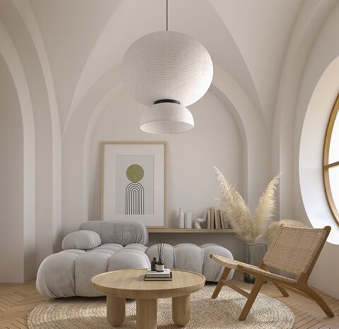 Arched plaster living space with globe pendant lights and a rounded modular sofa